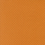 Orange fabric with small white polka dots