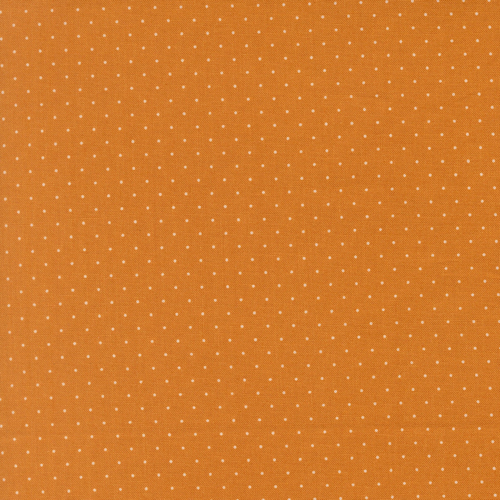 Orange fabric with small white polka dots
