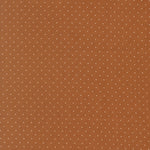 Brown fabric with small white polka dots