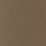 A close-up of a brown fabric or material swatch with a repeating pattern of small white polka dots.