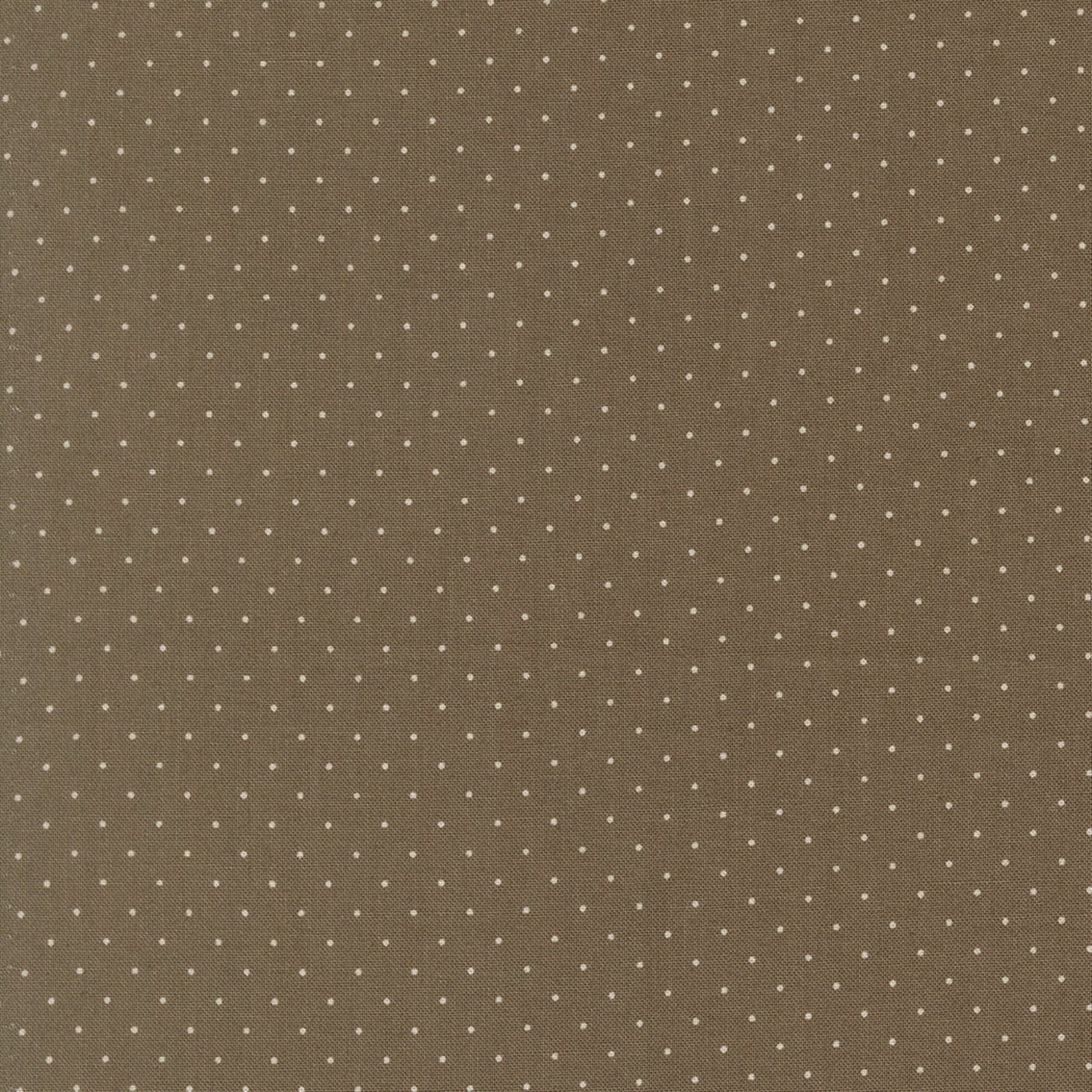 A close-up of a brown fabric or material swatch with a repeating pattern of small white polka dots.