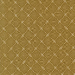 A close-up of a repeating fabric or wallpaper pattern in warm olive-gold and beige, showing a diamond lattice made of small dots and decorative floral motifs.
