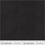 A close-up of a dark charcoal gray fabric texture with a white ruler at the bottom displaying measurements and the Windham Fabrics logo.