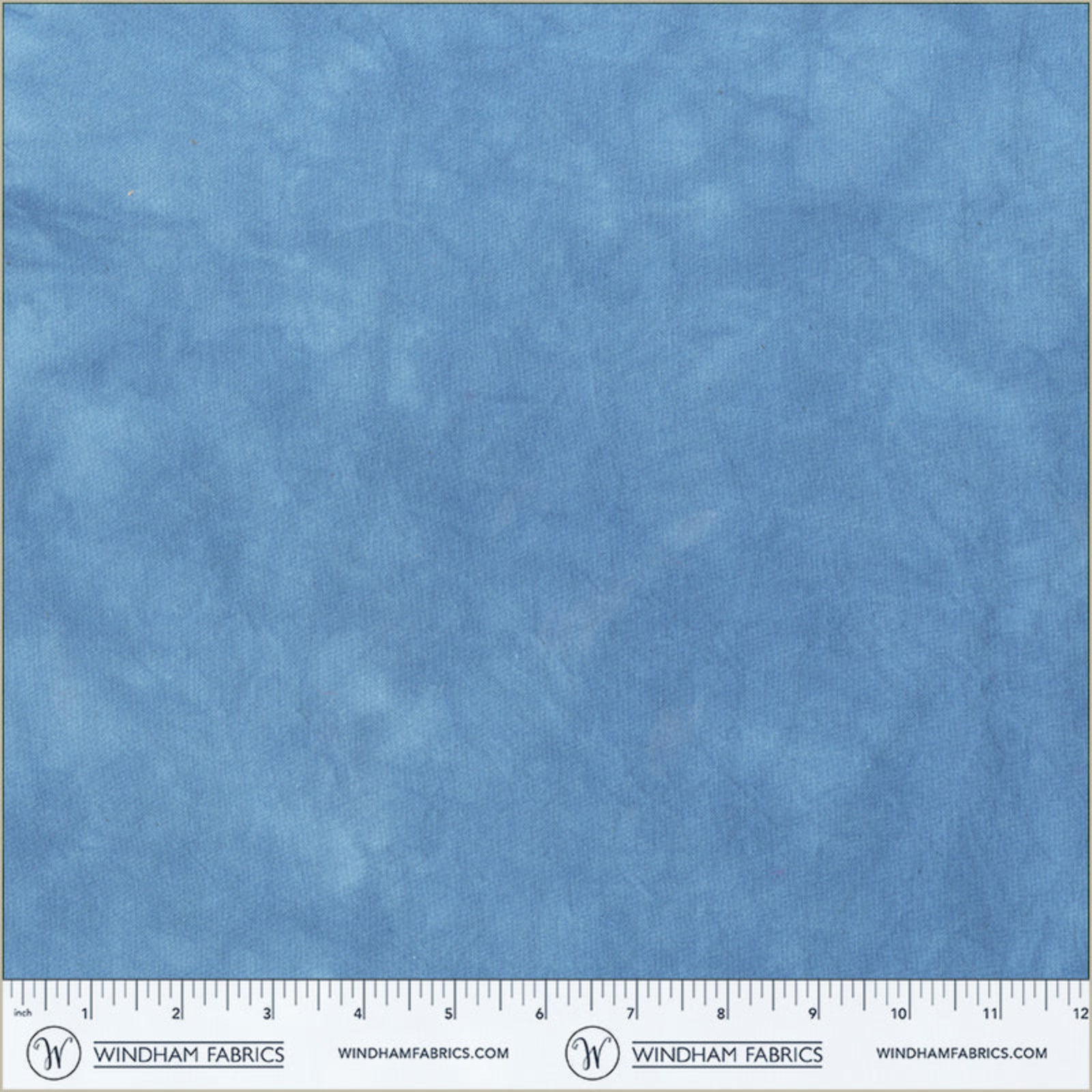 Blue fabric swatch with a ruler at the bottom for scale, branded 'Windham Fabrics'.