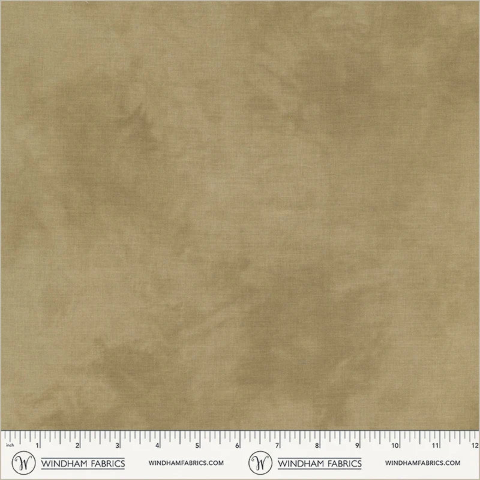 A close-up of a fabric swatch in a warm taupe-beige color with a subtle mottled texture, featuring a Windham Fabrics ruler along the bottom edge.