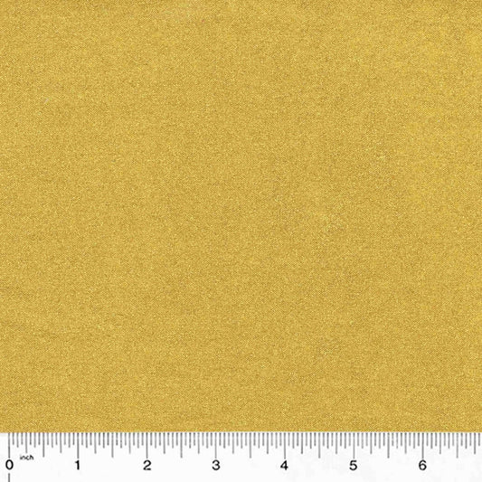 gold metallic cotton fabric with a ruler at the bottom for scale.