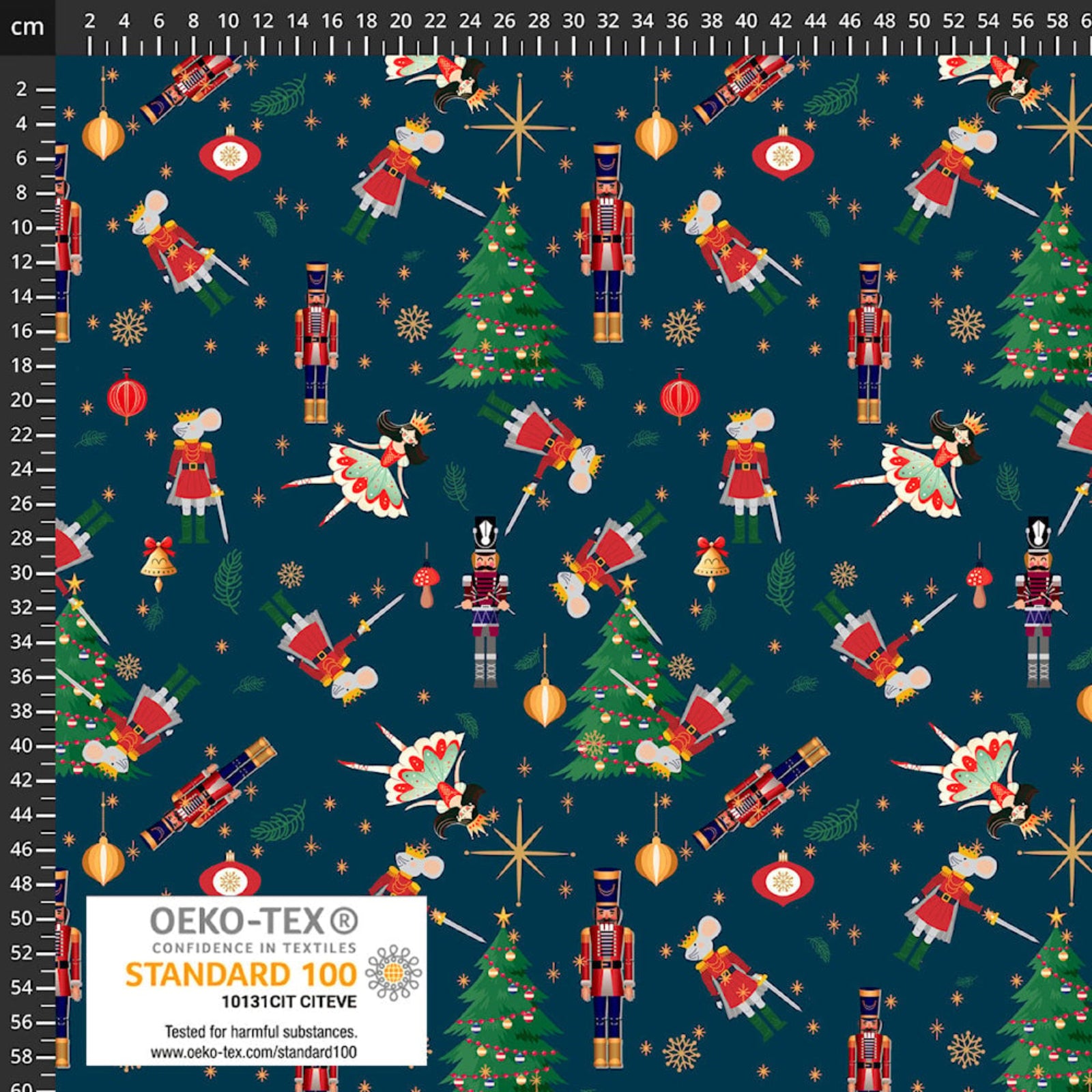 A close-up of a dark navy holiday-themed fabric pattern featuring nutcrackers, Christmas trees, ornaments, stars, and bells, with a white OEKO-TEX Standard 100 label at the bottom and a black measurement ruler along the top and left edge.