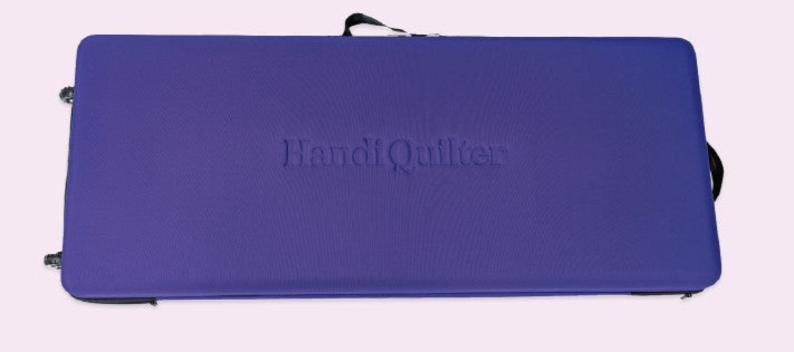 A purple rectangular quilt case with the brand name 'Handi Quilter' embossed in the center, shown against a pale pink background.