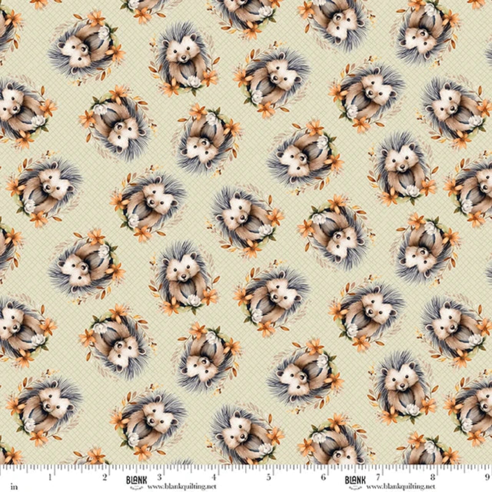 A repeating pattern of hedgehogs with orange flowers on a light beige background, shown as a fabric or paper print with a BLANK brand ruler along the bottom edge.
