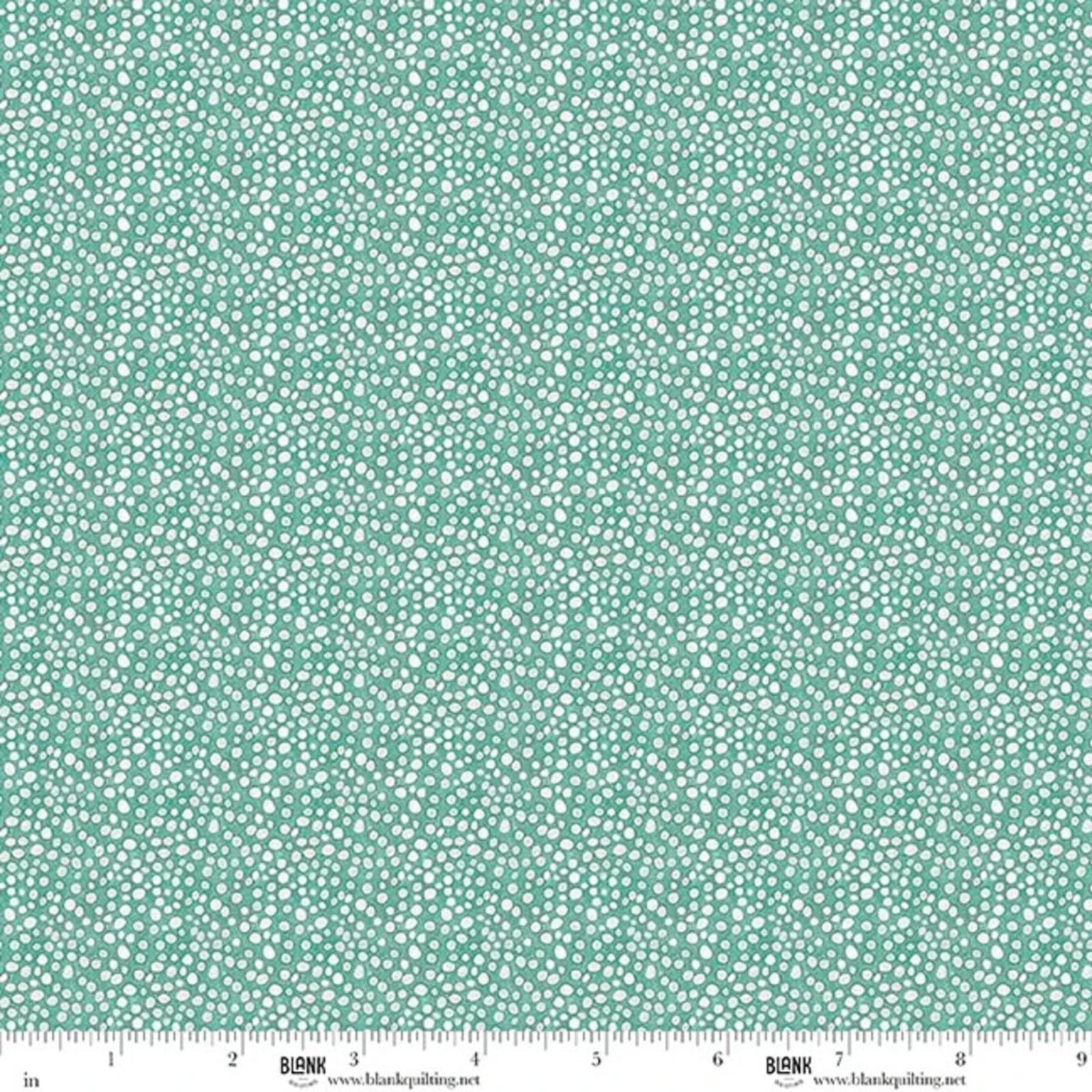 A close-up of a fabric pattern featuring a dense, small-scale white ditsy print on a soft teal-green background, with a white measurement ruler visible along the bottom edge.