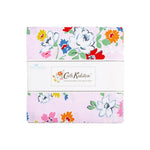 A folded fabric bundle from Cath Kidston Signature Collection by Blue Blake, featuring a light pink background with a colorful floral pattern of white, blue, red, yellow, and pink flowers, wrapped in a white paper band.