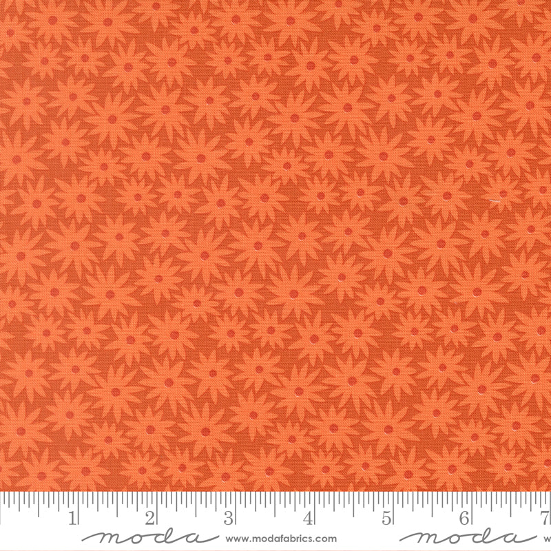 Patterned fabric with red flowers on an orange background.