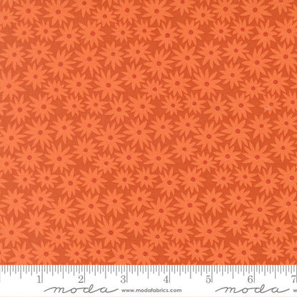 Patterned fabric with red flowers on an orange background.