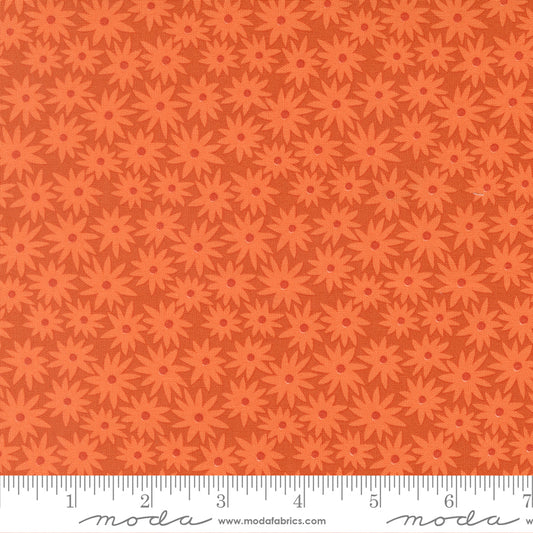 Patterned fabric with red flowers on an orange background.