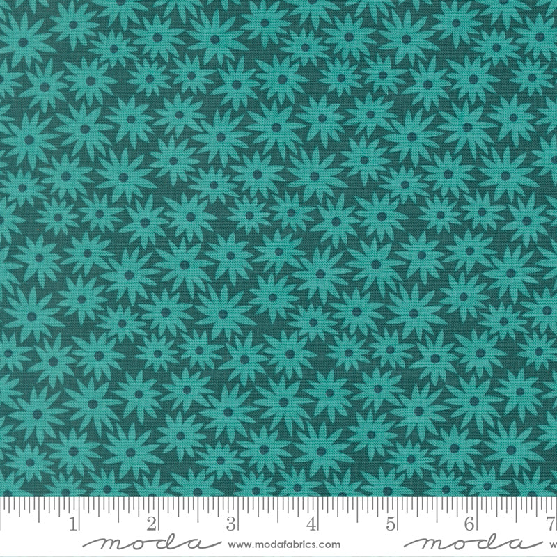 Teal floral pattern on a dark green background with a ruler for scale.