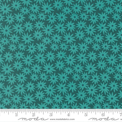Teal floral pattern on a dark green background with a ruler for scale.