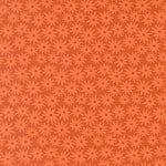 Pattern of red flowers on a brown background