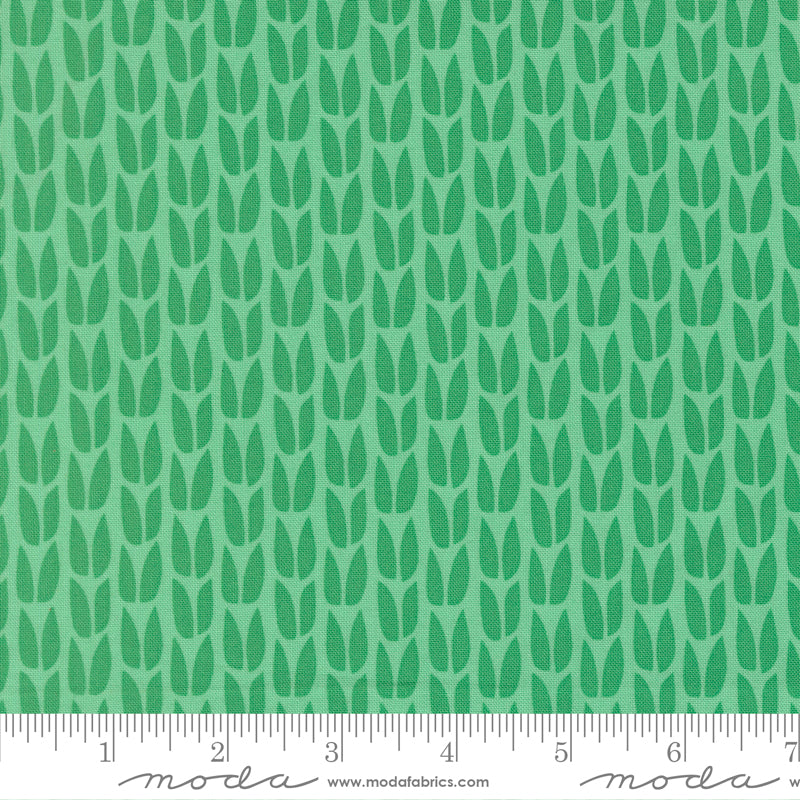 Green leaf pattern fabric with a ruler at the bottom