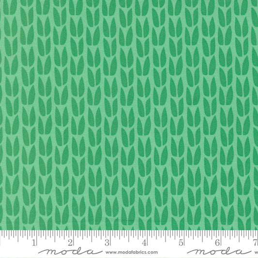 Green leaf pattern fabric with a ruler at the bottom