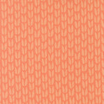 Patterned fabric with a subtle leaf design on a peach background