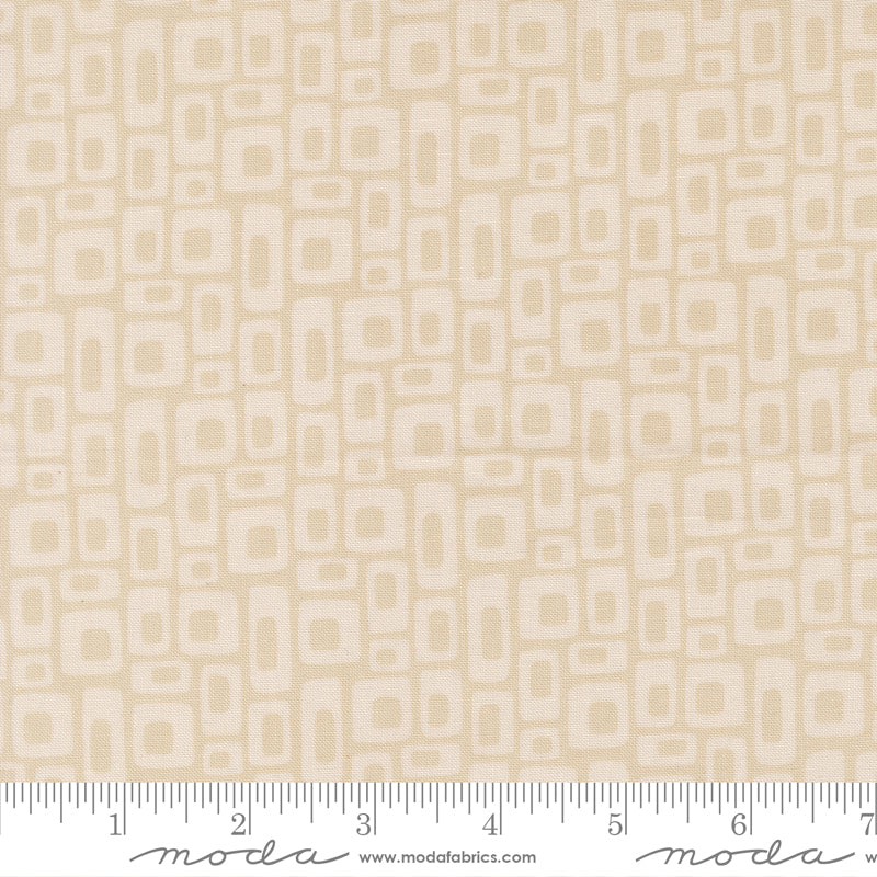 Beige fabric with geometric pattern with a ruler for scale