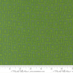 Green fabric with geometric pattern and ruler for scale