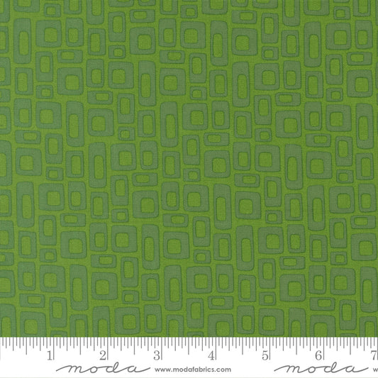 Green fabric with geometric pattern and ruler for scale