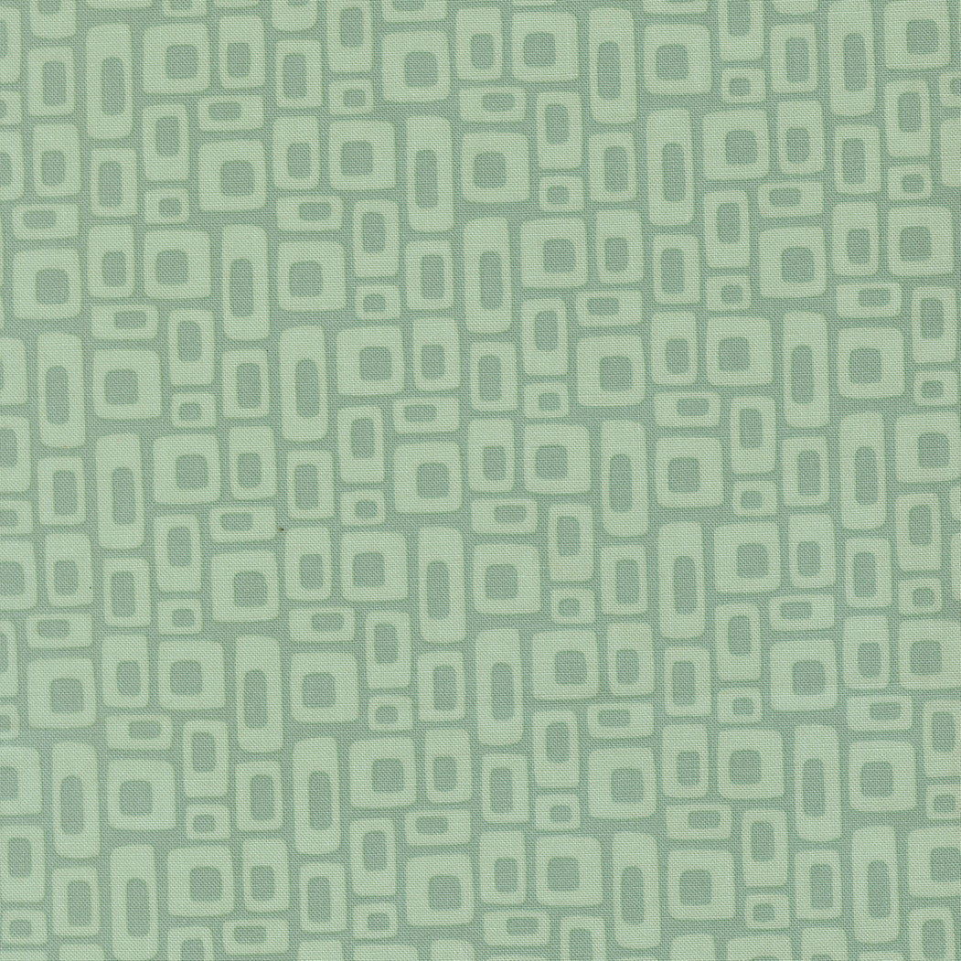 Patterned fabric with geometric shapes on a green background