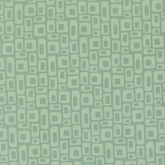 Patterned fabric with geometric shapes on a green background