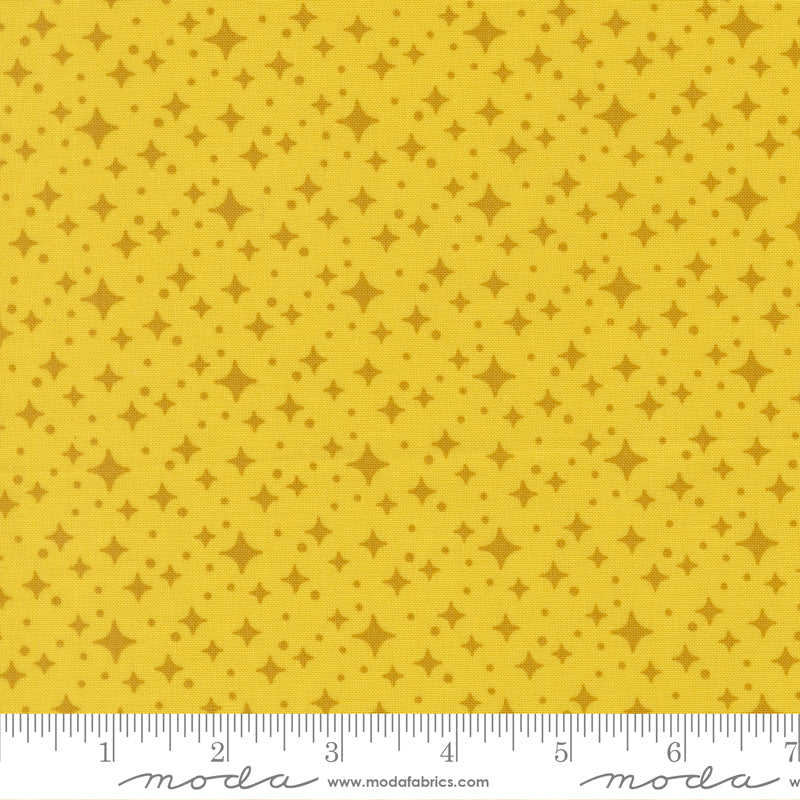 Yellow fabric with star pattern with a ruler for scale