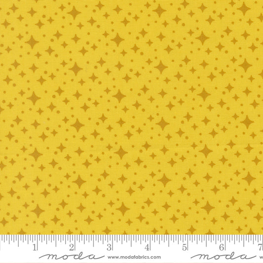 Yellow fabric with star pattern with a ruler for scale