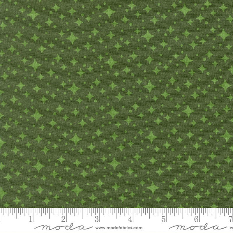 Green fabric with star pattern with a ruler for scale