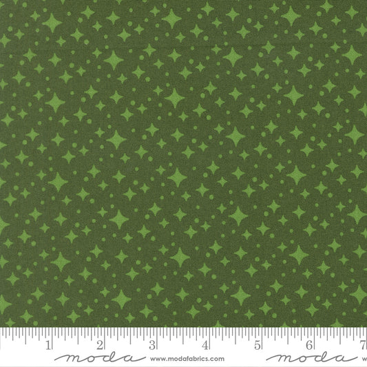 Green fabric with star pattern with a ruler for scale