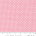 Pink fabric with a subtle pattern and Moda label, featuring a ruler at the bottom.
