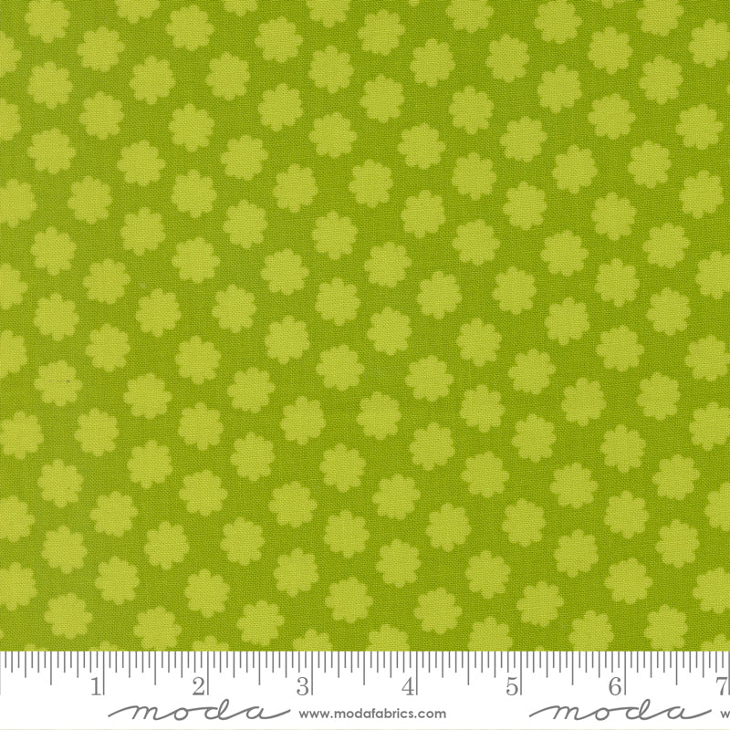 Green fabric with small floral pattern and ruler at the bottom