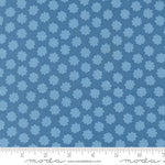 Blue fabric pattern with a ruler for scale on a blue background