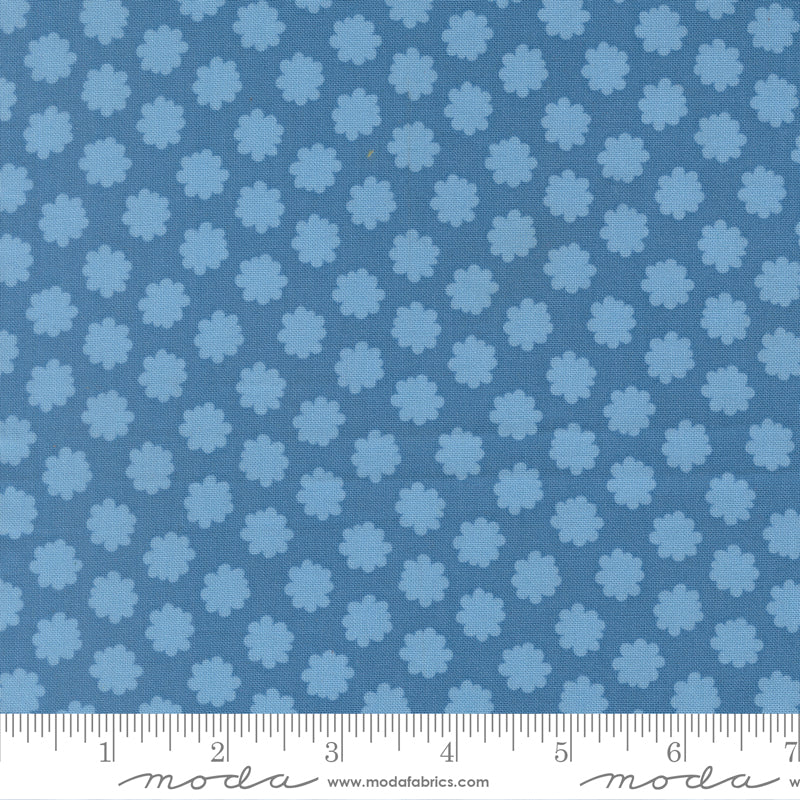 Blue fabric pattern with a ruler for scale on a blue background