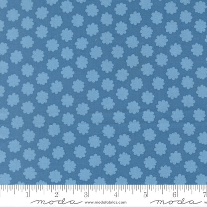 Blue fabric pattern with a ruler for scale on a blue background