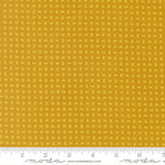 Yellow fabric with a small pattern and a ruler at the bottom for scale.