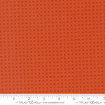 Orange fabric with a subtle pattern and a ruler at the bottom for scale.