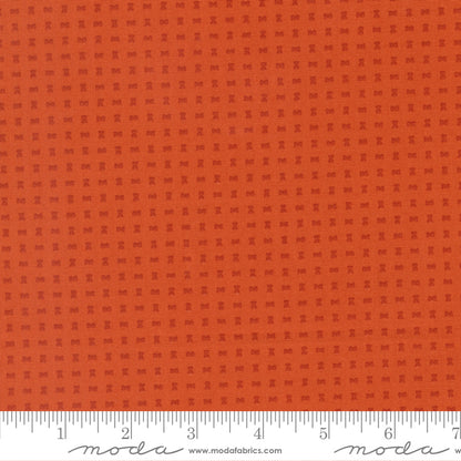 Orange fabric with a subtle pattern and a ruler at the bottom for scale.