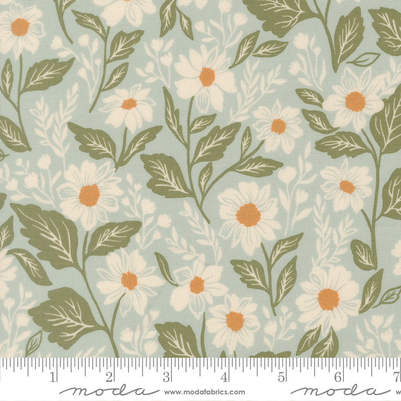 Floral pattern with white flowers and green leaves on a light blue background, featuring a ruler for scale