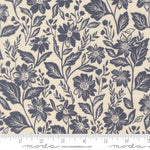 Floral pattern fabric with a ruler at the bottom for scale, featuring navy flowers and leaves on a beige background.