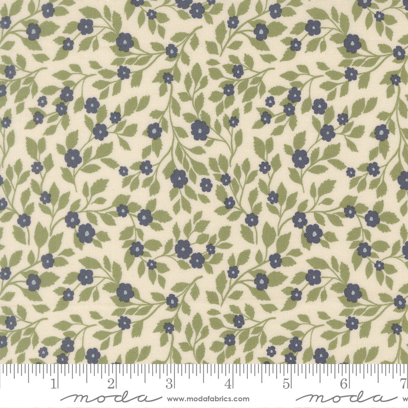 Floral pattern fabric with blue flowers and green leaves on a beige background, featuring a ruler for scale