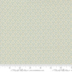 Fabric swatch with a geometric floral pattern on a light blue background, featuring Moda label.