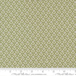 Green fabric with small floral pattern with a ruler for scale