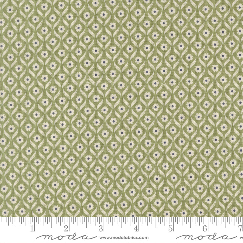 Green fabric with small floral pattern with a ruler for scale