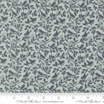 Fabric pattern with birds and leaves on a teal background with a ruler for scale