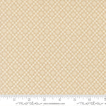 Beige fabric with a subtle diamond pattern with a ruler for scale