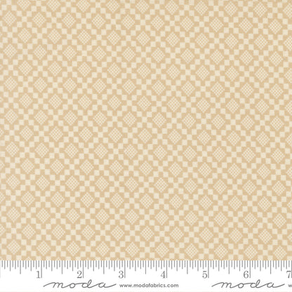 Beige fabric with a subtle diamond pattern with a ruler for scale